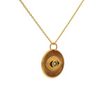 Gold necklace with textured eye medal and stone