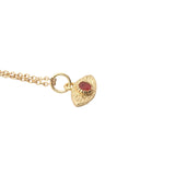 Gold necklace with hammered eye medal and stone