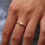 Golden ring with stone and two zircons