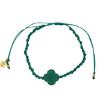 Gold cord bracelet with clover and faceted stone