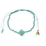 Gold cord bracelet with clover and faceted stone