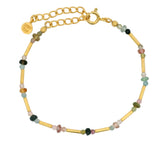 Golden bracelet with tubes and faceted stones