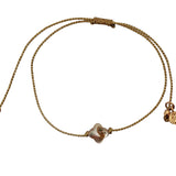 Gold cord bracelet and mother-of-pearl clover