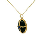 Gold necklace with cabochon stone and gold cage