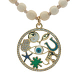 Collier médaillon doré perles en os symboles chance 90 cm