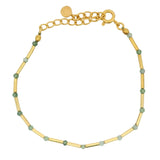Golden bracelet with rods and natural stones