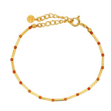 Bracelet doré pierre de lune orange alternée avec des tubes dorés