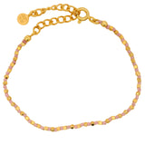 Bracelet doré avec perles martelées dorées et noeuds roses