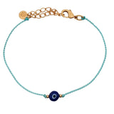 Bracelet doré cordon turquoise avec oeil rond bleu foncé