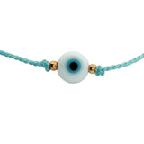 Bracelet doré cordon turquoise avec oeil rond blanc