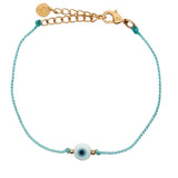 Bracelet doré cordon turquoise avec oeil rond blanc