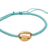 Bracelet sur cordon turquoise avec cauri doré