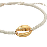 Bracelet sur cordon crème avec cauri doré