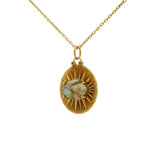 Gold necklace with sunray medal and faceted stone