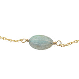 Golden bracelet with faceted oval stone