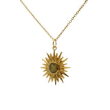 Golden necklace with sun pendant and faceted stone