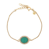 Golden bracelet with faceted oval stone and zircons