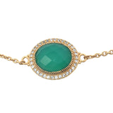 Golden bracelet with faceted oval stone and zircons