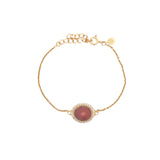 Golden bracelet with faceted oval stone and zircons