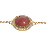 Golden bracelet with faceted oval stone and zircons