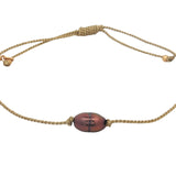 Bracelet doré avec perle de culture grise