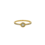 Golden ring with round stone and zircons