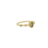 Golden ring with oval stone and zircons