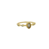 Golden ring with oval stone and zircons