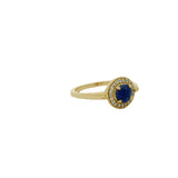Golden ring with round stone and zircons