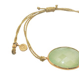 Gold cord bracelet with faceted stone