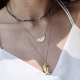 Gold necklace with engraved flower pendant