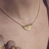 Gold necklace with engraved flower pendant