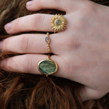 Gold ring and flat oval stone