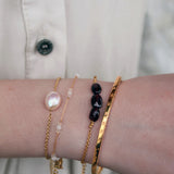 Gold wire bracelet and small natural stones